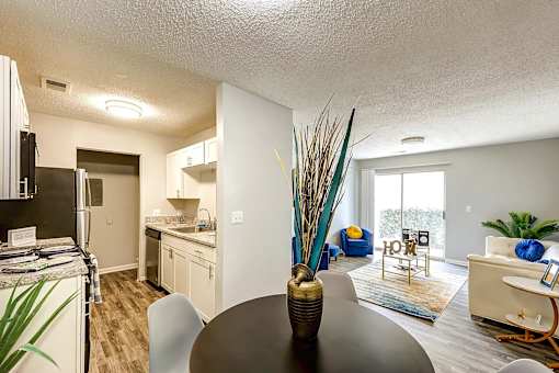 A modern kitchen with a dining table and chairs at Sedgefield Square Apartments, Greensboro, NC, 27407