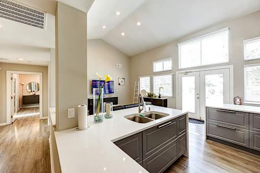A modern kitchen with a white countertop and wooden cabinets at Sedgefield Square Apartments, North Carolina