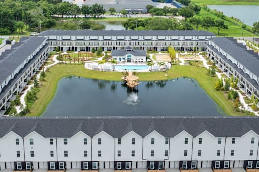 A large white building with a pool in the middle of it.