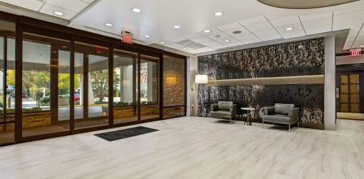 a lobby with two chairs and a table at The Ivanhoe Apartments, New Jersey, 07601