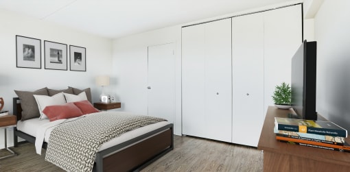 a bedroom with white walls and a bed with a red pillow at The Ivanhoe Apartments, Hackensack, 07601