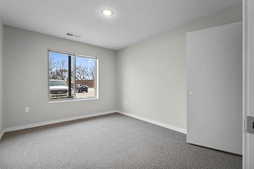 A room with a window and a door.