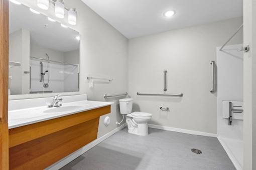 A bathroom with a white sink and toilet.