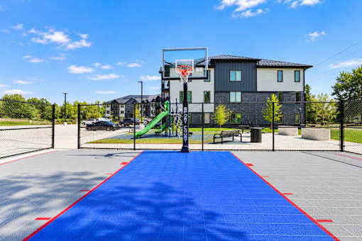 A basketball court with a blue surface and red boundary lines.