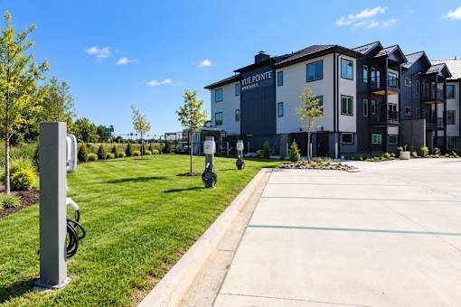 A parking lot in front of a building with a sign that says Vue Pointe.