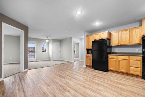 A kitchen with wooden cabinets and black appliances.