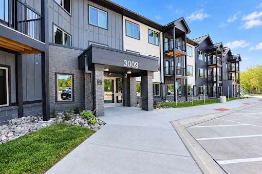 The image shows a modern building with the number 3009 on it.