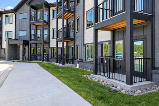 A modern apartment building with balconies and railings.