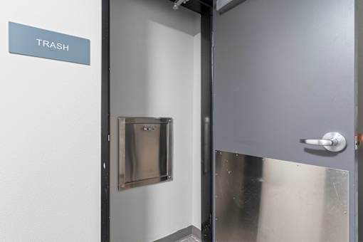 a door with a sign that reads trash on the side of it