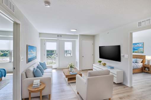 A living room with a television, couch, and a coffee table.