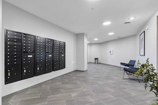 a large locker room in a room with white walls and tile flooring