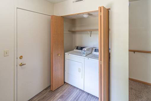 A small laundry room with a washer and dryer.