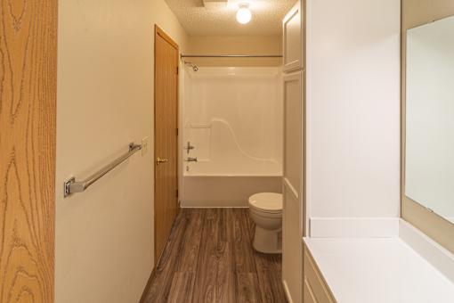 A small bathroom with a toilet, sink and bathtub.