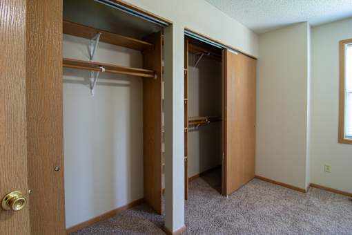 A room with a closet and a door.