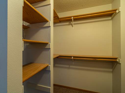 A white closet with three shelves.