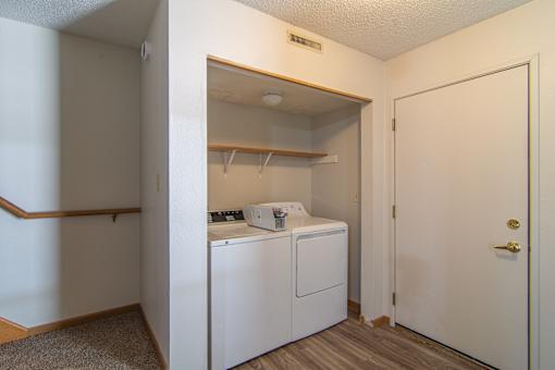A small laundry room with a washer and dryer.
