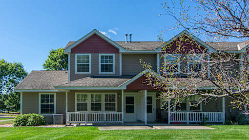 A house with a red roof and a white fence.
