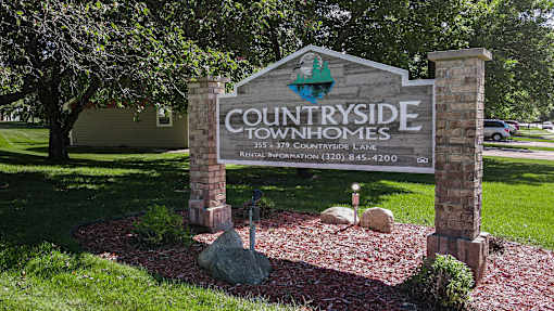 A sign for Countryside Townhomes with a phone number on it.