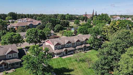 A bird's eye view of a residential area with houses and trees.