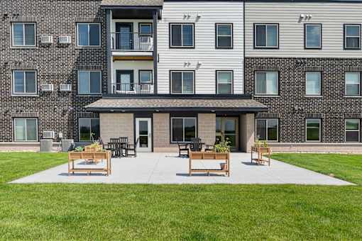 our apartments have a large patio with chairs and tables