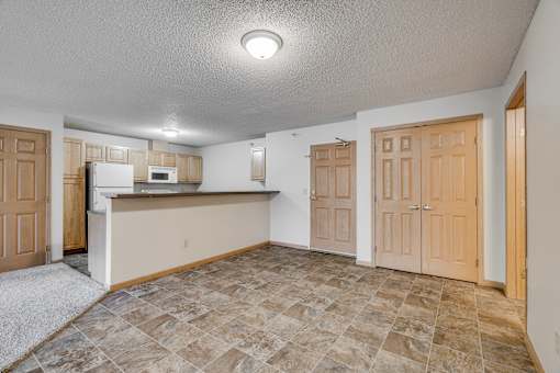 A kitchen area with a microwave, oven, and refrigerator.