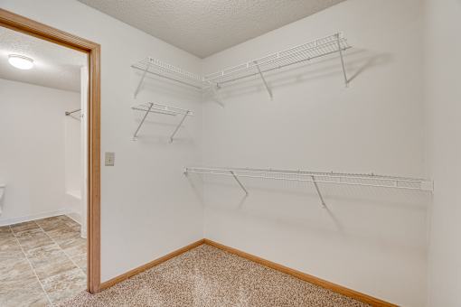 Walk-through closet with shelves.