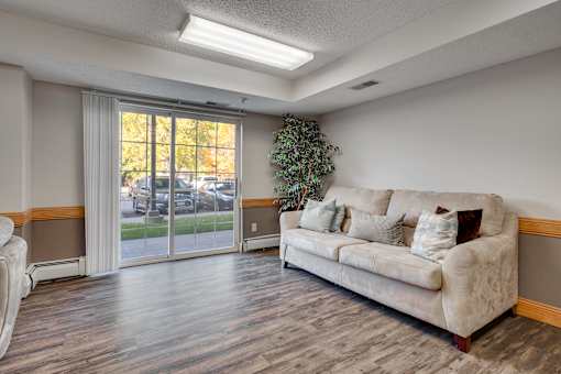 Community room with a sofa and patio door.