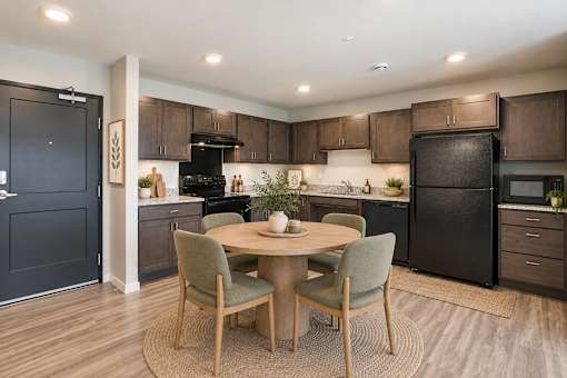 A modern kitchen with a dining table and chairs.