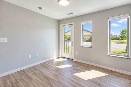 A room with a wooden floor and a white door.