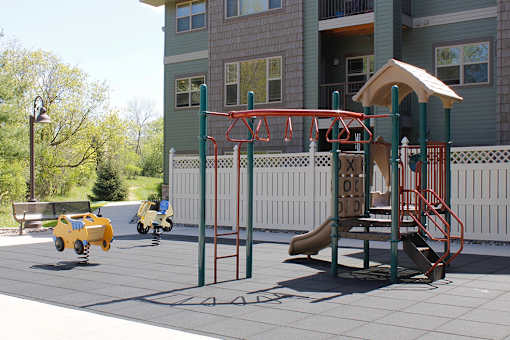 A family-friendly playground with a slide and monkey bars.