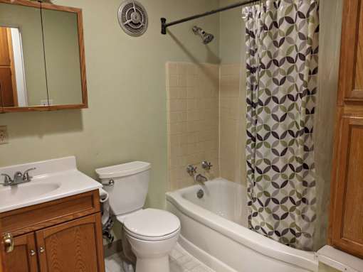 A bathroom with a toilet, sink, and bathtub.