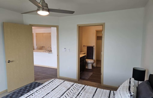 a bedroom with a bed and a bathroom with a toilet