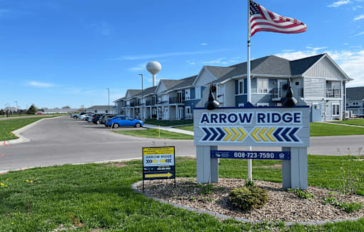 A sign for Arrow Ridge with a phone number on it.