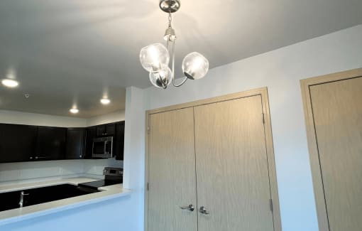 a kitchen with a cabinet and a chandelier