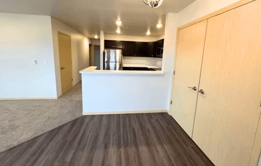 a kitchen and a living room in a empty apartment