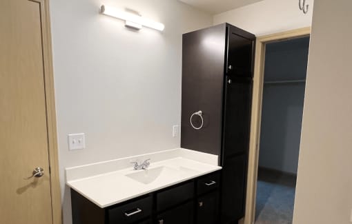 an empty bathroom with a sink and a shower