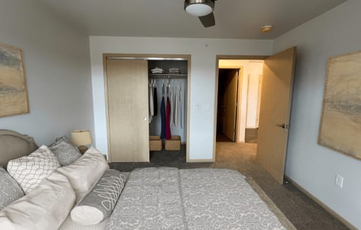 a living room with a couch and a hallway with a closet