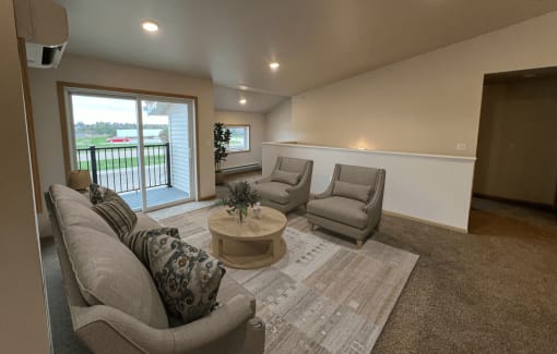 a living room with couches and chairs and a rug