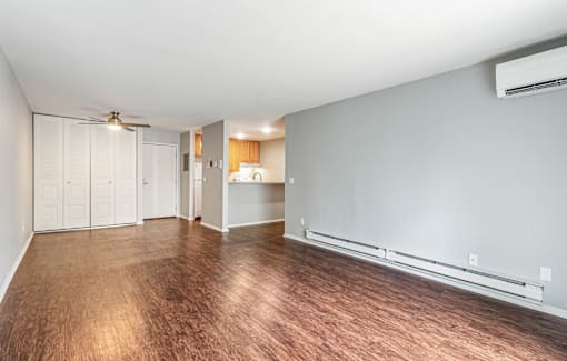 A room with wood flooring and a ceiling fan.