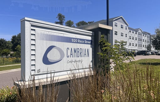A large white sign with a blue logo and the word