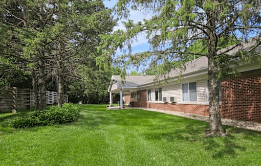 a backyard with green grass and trees