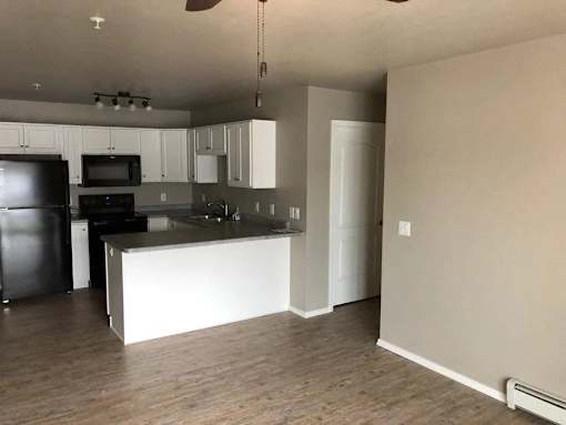 A kitchen with wooden cabinets and stainless steel appliances.