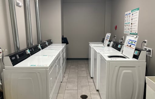 A row of washing machines in a laundromat.