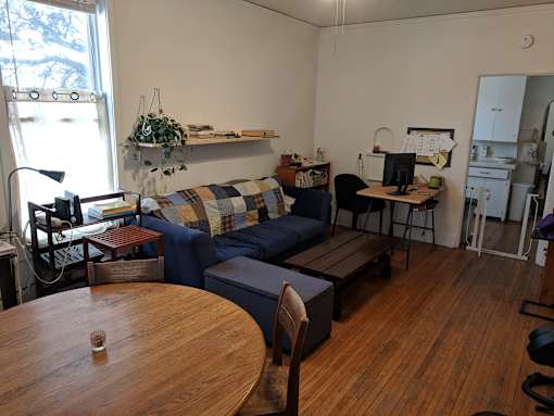 A living room with a couch, chair, and table.