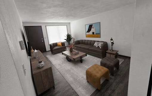 A living room with a brown couch, a coffee table, and a painting on the wall.