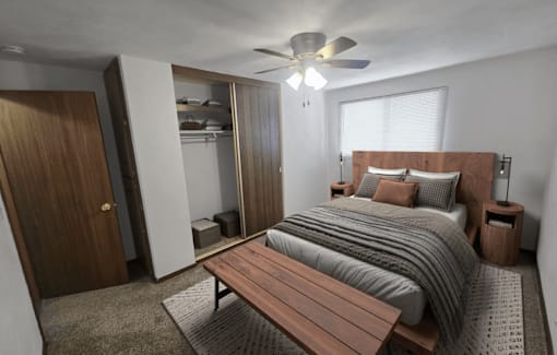 A bedroom with a bed, a bench, and a ceiling fan.