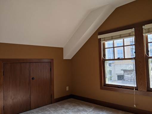 A room with brown walls and a wooden door.