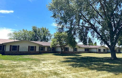 A house with a tree in front of it.