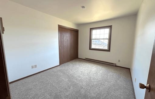 A room with a car parked outside the window.