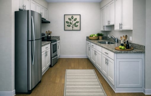 A kitchen with a refrigerator, microwave, and oven.